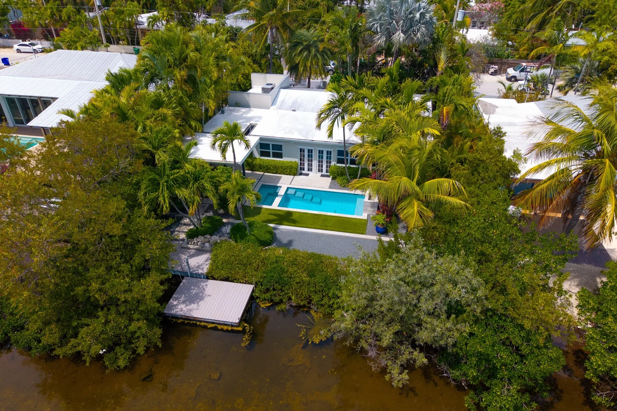 Aerial view of Key West vacation rental — private pool, dock access, tropical canopy
